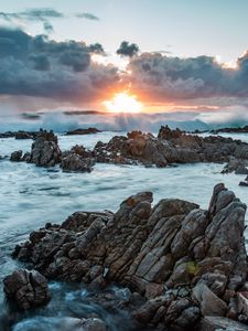 Preview wallpaper sunset, rocks, sea, stones, clouds