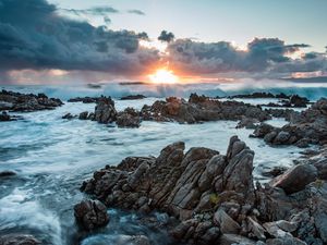 Preview wallpaper sunset, rocks, sea, stones, clouds