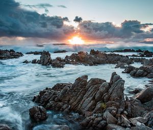 Preview wallpaper sunset, rocks, sea, stones, clouds
