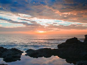 Preview wallpaper sunset, rocks, sea, clouds, stones