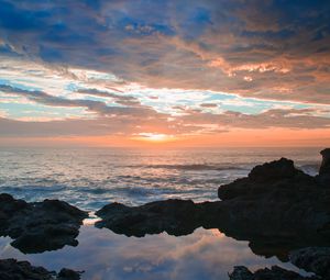 Preview wallpaper sunset, rocks, sea, clouds, stones
