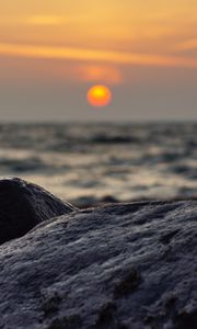 Preview wallpaper sunset, rocks, stones, sea, blur