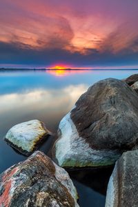Preview wallpaper sunset, rocks, water, stones, landscape