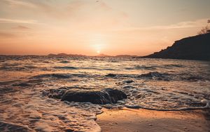 Preview wallpaper sunset, sea, beach, rocks, waves