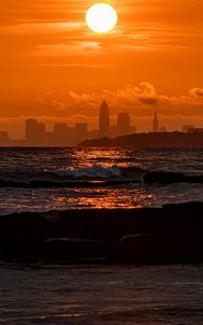 Preview wallpaper sunset, sea, city, dark, waves, horizon