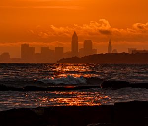 Preview wallpaper sunset, sea, city, dark, waves, horizon