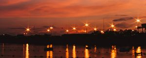 Preview wallpaper sunset, sea, lights, skyline, clouds, philippines