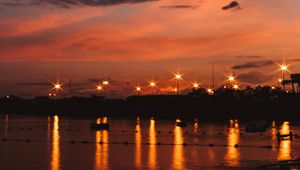 Preview wallpaper sunset, sea, lights, skyline, clouds, philippines