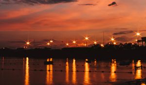 Preview wallpaper sunset, sea, lights, skyline, clouds, philippines