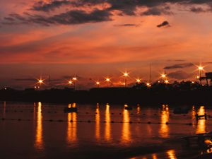 Preview wallpaper sunset, sea, lights, skyline, clouds, philippines