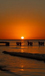 Preview wallpaper sunset, sea, pier, pilings