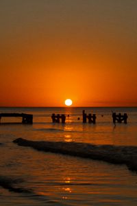 Preview wallpaper sunset, sea, pier, pilings