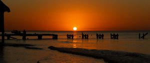 Preview wallpaper sunset, sea, pier, pilings