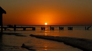 Preview wallpaper sunset, sea, pier, pilings