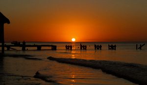 Preview wallpaper sunset, sea, pier, pilings