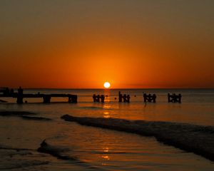 Preview wallpaper sunset, sea, pier, pilings