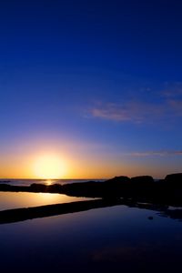 Preview wallpaper sunset, sea, rocks, outlines, silence, horizon