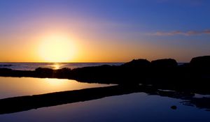 Preview wallpaper sunset, sea, rocks, outlines, silence, horizon