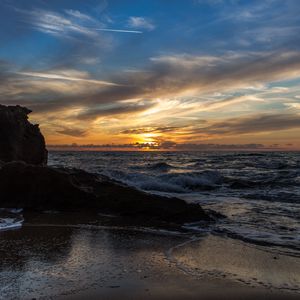 Preview wallpaper sunset, sea, rocks, coast, surf