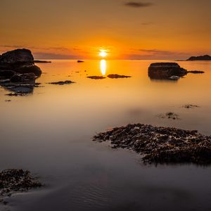 Preview wallpaper sunset, sea, rocks, horizon