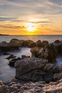 Preview wallpaper sunset, sea, rocks, water, landscape