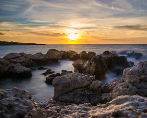 Preview wallpaper sunset, sea, rocks, water, landscape