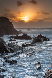 Preview wallpaper sunset, sea, rocks, waves, landscape