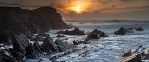 Preview wallpaper sunset, sea, rocks, waves, landscape