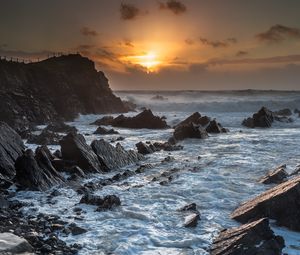 Preview wallpaper sunset, sea, rocks, waves, landscape