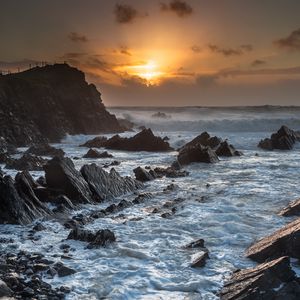 Preview wallpaper sunset, sea, rocks, waves, landscape