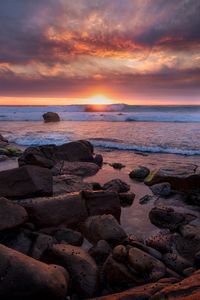 Preview wallpaper sunset, sea, shore, stones, landscape