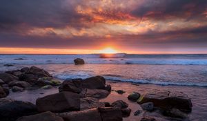 Preview wallpaper sunset, sea, shore, stones, landscape