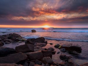 Preview wallpaper sunset, sea, shore, stones, landscape