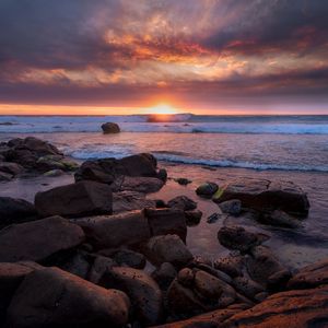 Preview wallpaper sunset, sea, shore, stones, landscape