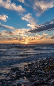 Preview wallpaper sunset, sea, sky, pier, stones