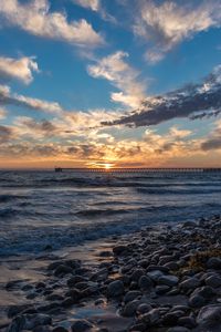 Preview wallpaper sunset, sea, sky, pier, stones