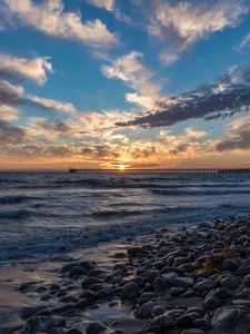 Preview wallpaper sunset, sea, sky, pier, stones
