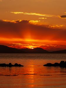 Preview wallpaper sunset, sea, stones, hills, sky