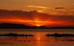 Preview wallpaper sunset, sea, stones, hills, sky