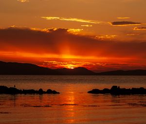 Preview wallpaper sunset, sea, stones, hills, sky