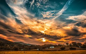 Preview wallpaper sunset, sky, clouds, field, trees, horizon