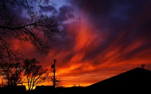 Preview wallpaper sunset, sky, clouds, silhouette, trees, wires, evening