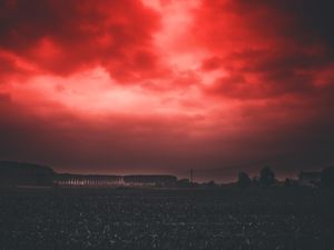 Preview wallpaper sunset, sky, horizon, field, clouds, red