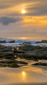 Preview wallpaper sunset, sky, stones, coast, sand