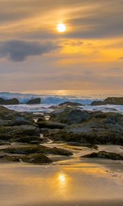 Preview wallpaper sunset, sky, stones, coast, sand
