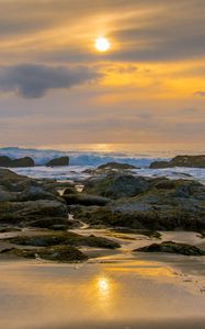 Preview wallpaper sunset, sky, stones, coast, sand