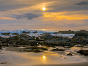 Preview wallpaper sunset, sky, stones, coast, sand