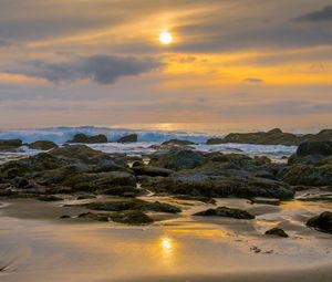 Preview wallpaper sunset, sky, stones, coast, sand