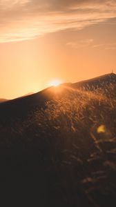 Preview wallpaper sunset, slope, sun, hill, rays