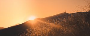 Preview wallpaper sunset, slope, sun, hill, rays